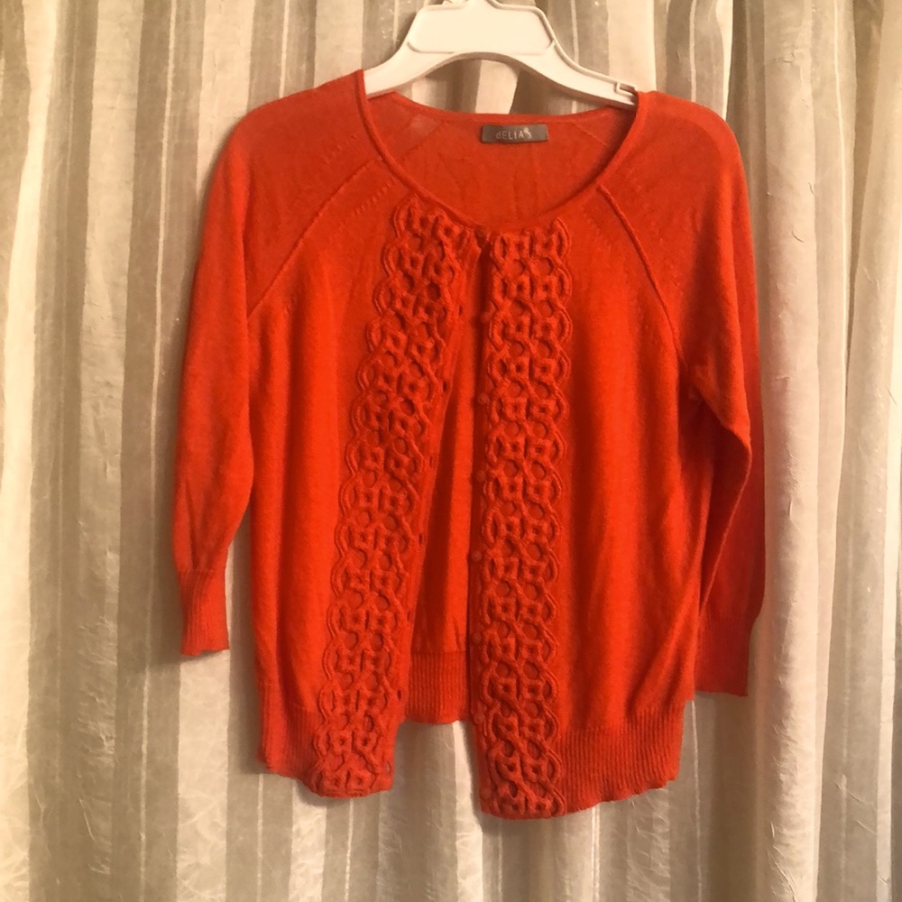 Delia’s Vibrant Coral Cardigan with Intricate Knit